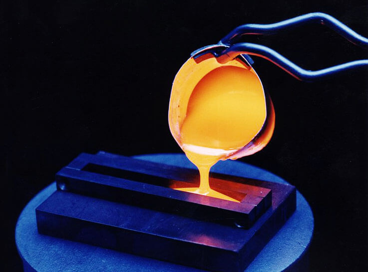Melted nuclear waste material being cast into a metal form
