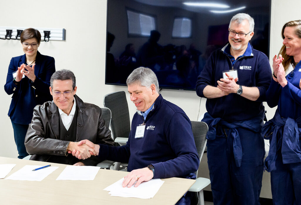 CEO Rod Baltzer shaking hands, a sign of optimism for the Deep Borehole Demonstration Project, Cameron, TX